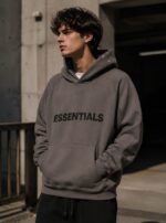 Dark grey Essentials hoodie for men and women, pullover style, casual winter wear.