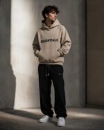 Beige unisex Essentials hoodie with cozy hood and front pocket.