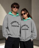 Unisex grey Fear of God Essentials nylon hoodie with oversized fit
